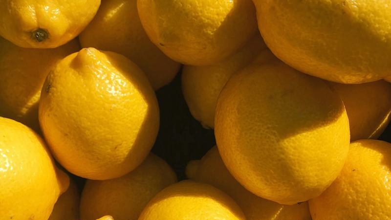Close-up shot of bright yellow lemons taking up the whole image.